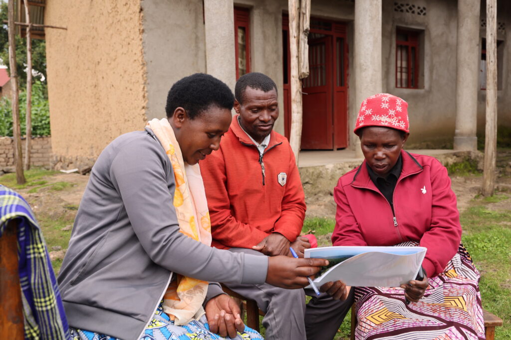 A sales agent talking to a family in the Nyabihu District.