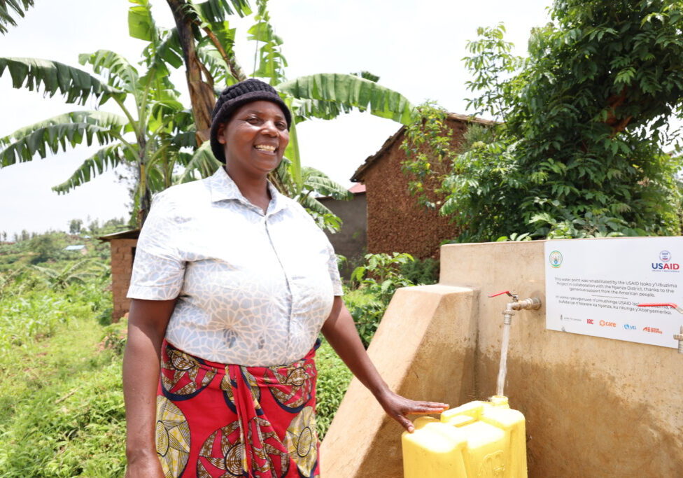 Farina Mujara fetches water from a newly rehabilitated water supply system in Cyabakamyi Sector, Nyanza District.