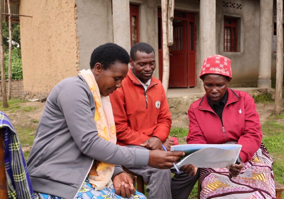 A sales agent talking to a family in the Nyabihu District.
