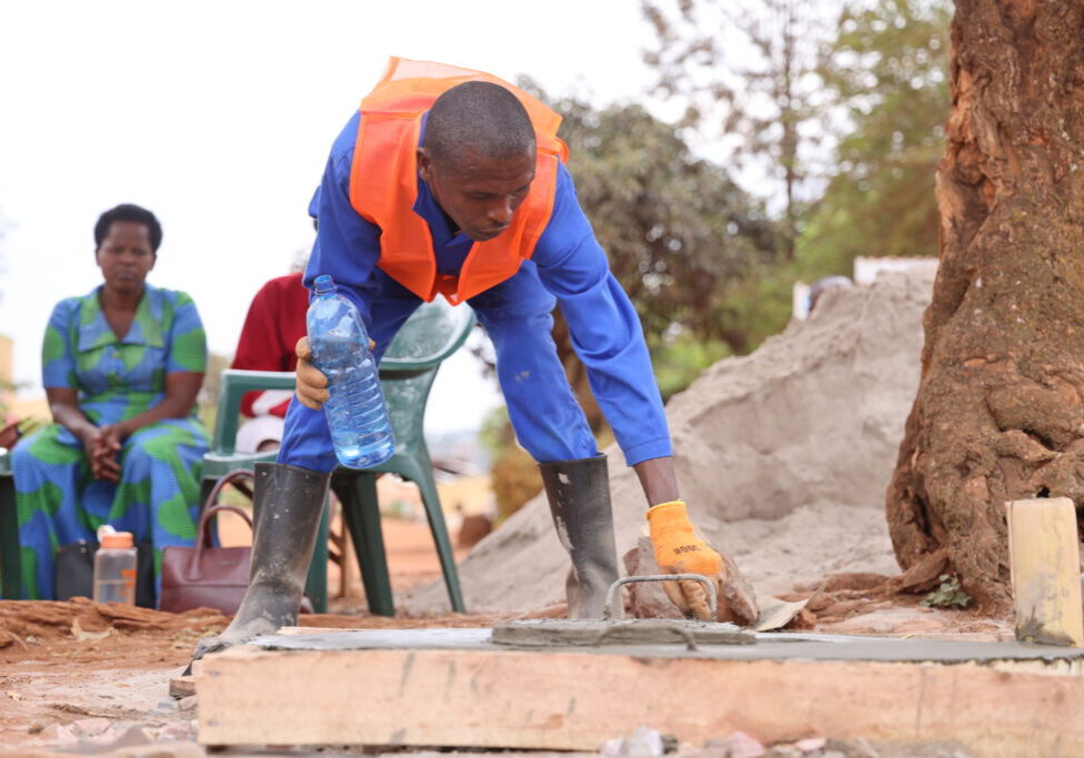 A local mason of the Nyakaliba Village constructing an improved slab.