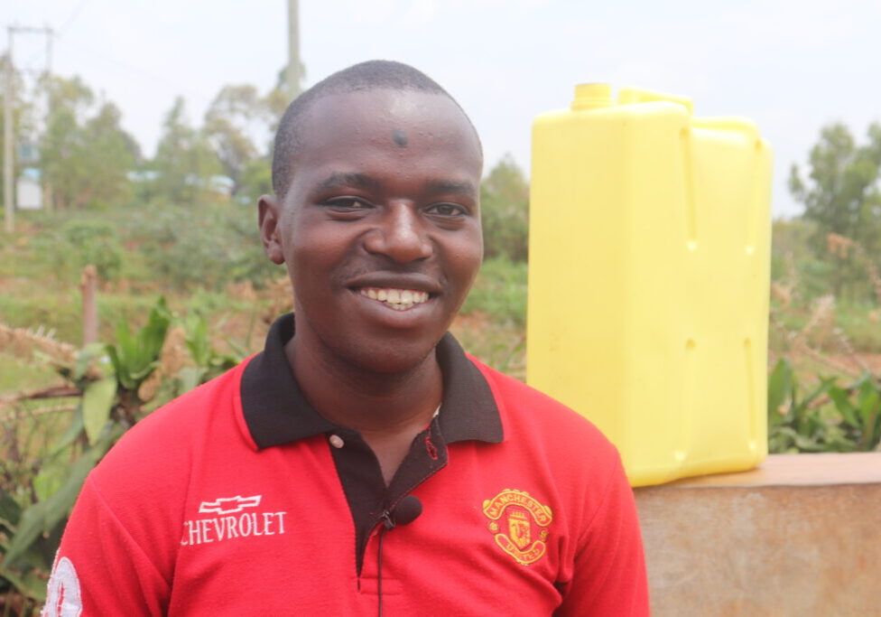 Theogene Ndayishimiye fetches water from a public water points built metres from his shop in Gicumbi (1)